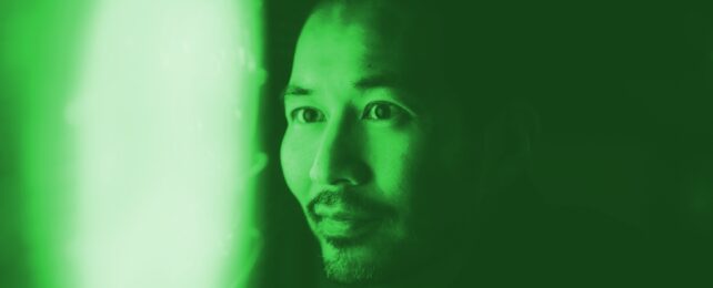 Man looks at green glow