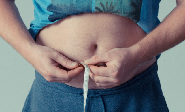 person measuring waist