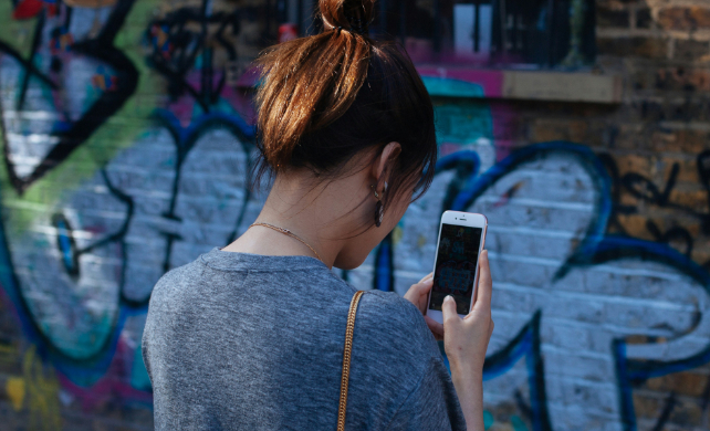 woman from behind looking at phone