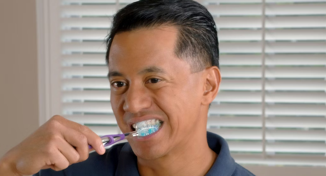 man brushing his teeth