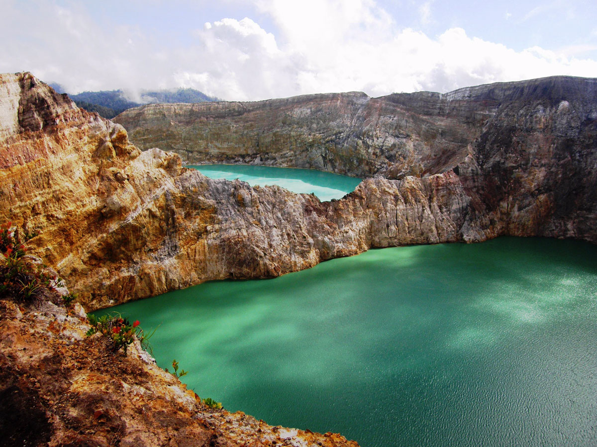 the-kelimutu-volcano-on-flores-island-indonesia-is-home-to-three-colored-lakes-ranging-from-turquoise-to-a-rich-green-the-lakes-are-incredibly-dense-adding-to-the-striking-appearance-of-their-colors-which-are-thought-to-be-caused-by-dissolv